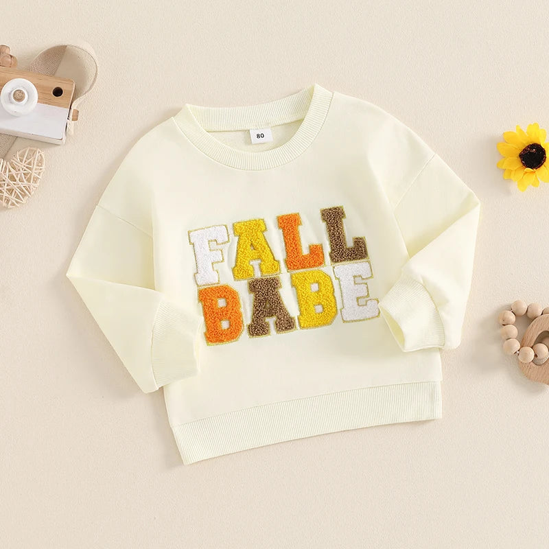 Pink baby and toddler fall crewneck top by August + Willow with embroidered letters and long sleeves, suitable for boys and girls.