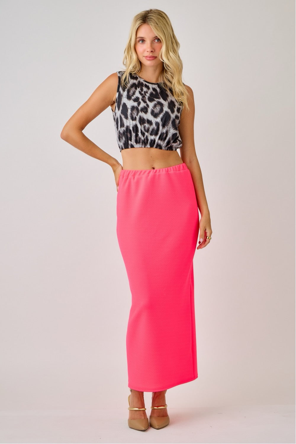 Celeste Clothing ladies maxi length pencil skirt in vibrant neon fuchsia, knee-length, fitted style for a sleek silhouette.
