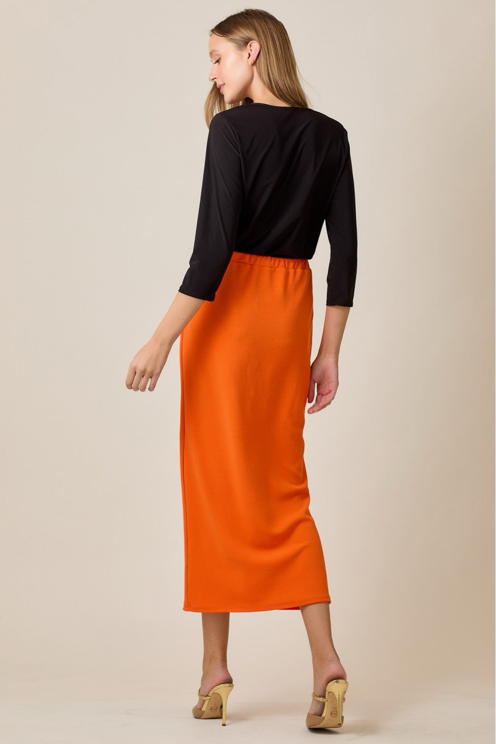 Orange ladies maxi-length pencil skirt by Celeste Clothing, featuring a sleek, fitted design and elegant style.