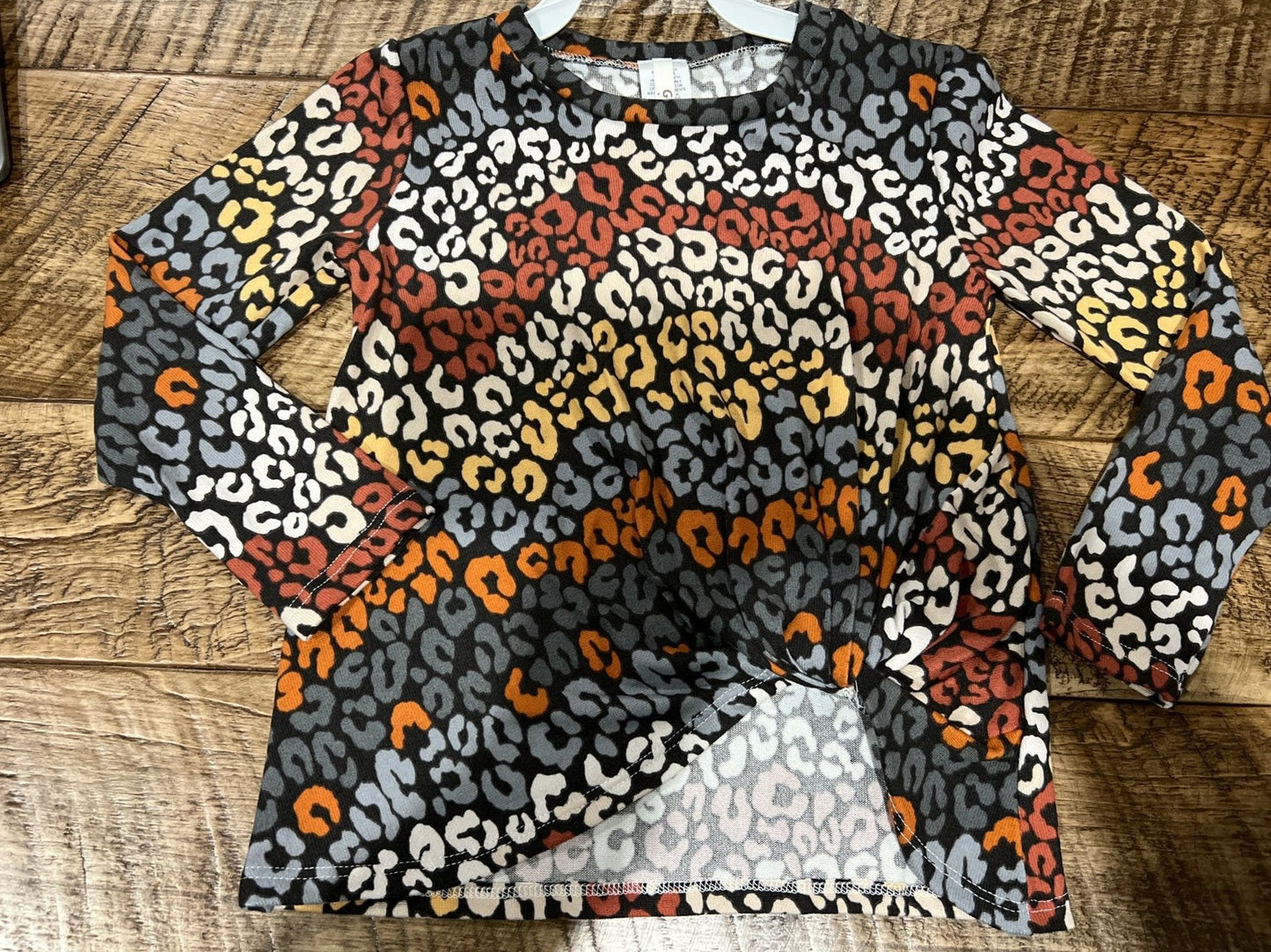 Girls long sleeve leopard print tunic top by GtoG with knotted front, made for stylish and comfortable wear.