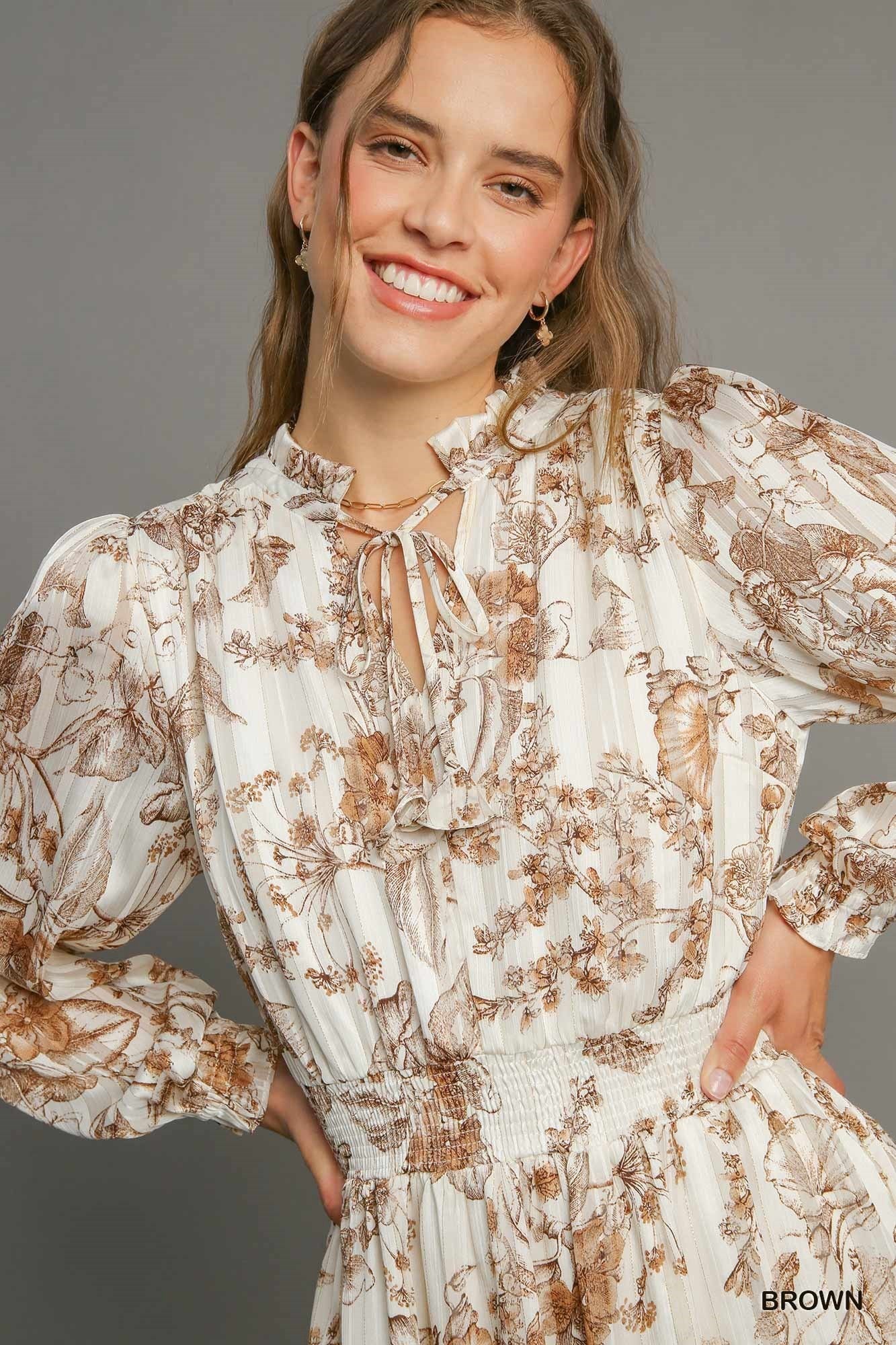 Umgee floral print tassel tie dress featuring lurex fabric, lightweight design, and stylish flowy silhouette for casual or semi-formal wear.