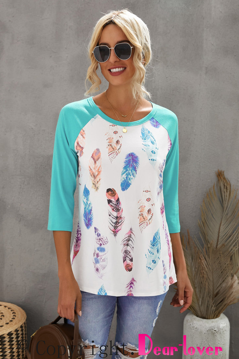 Feather print 3/4 sleeve raglan shirt with a relaxed fit, featuring a stylish feather pattern on soft fabric.