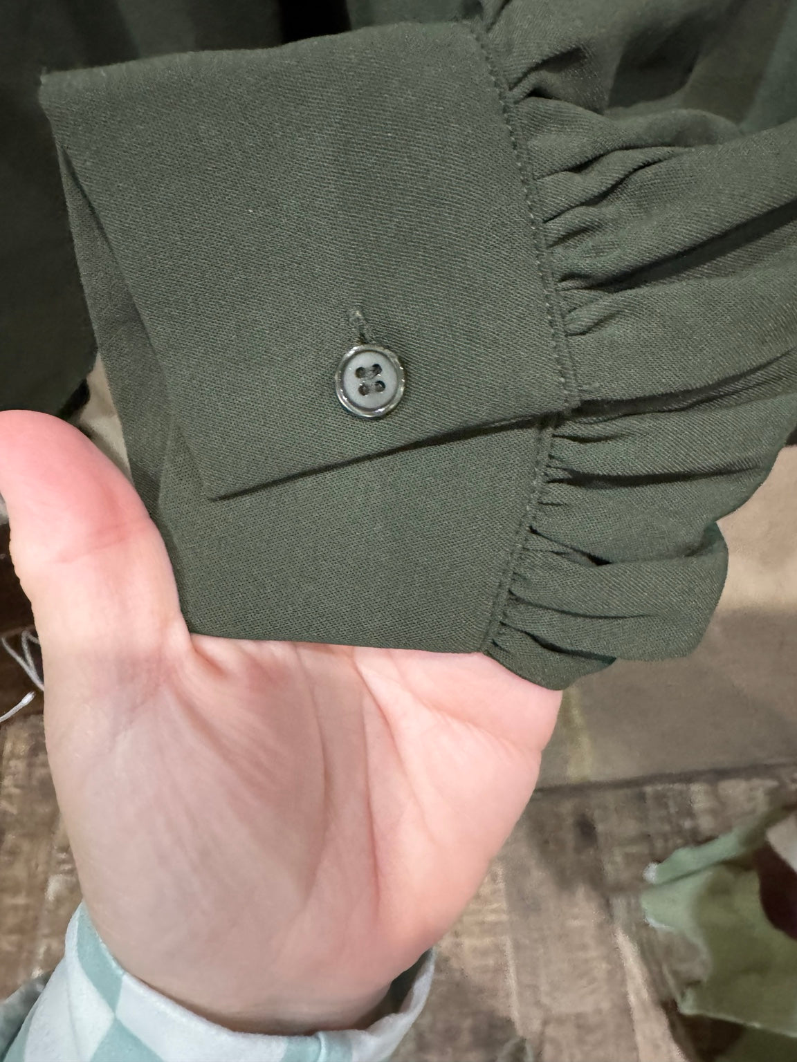 Andree dark olive blouse button cuff detail
