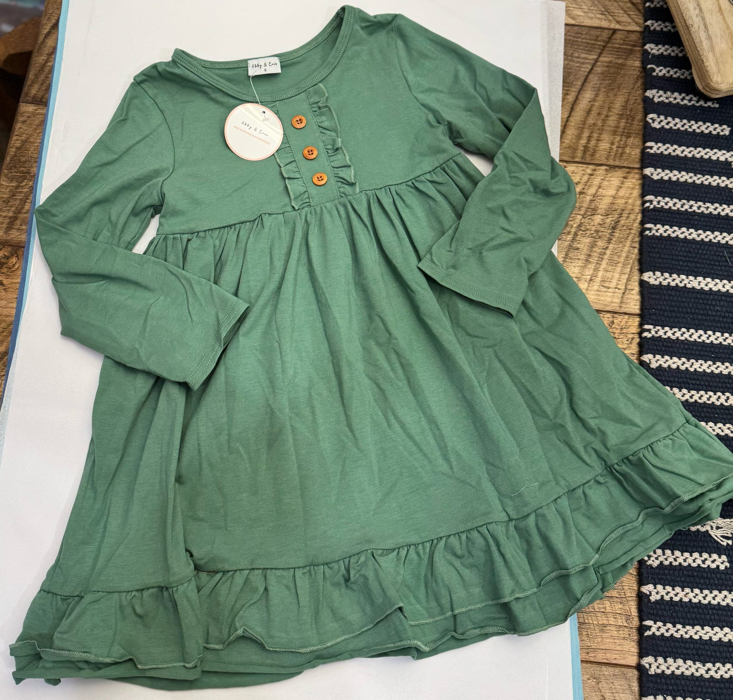 Orange girls' ruffle dress with long sleeves by Abby & Evie, featuring a cute, layered ruffle design for 12-month-old girls.