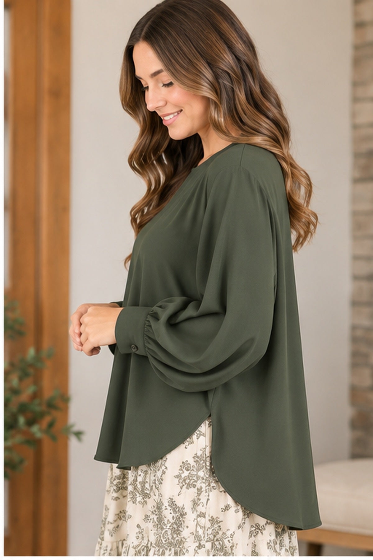 Side view of oversized olive blouse rounded hem and side vent