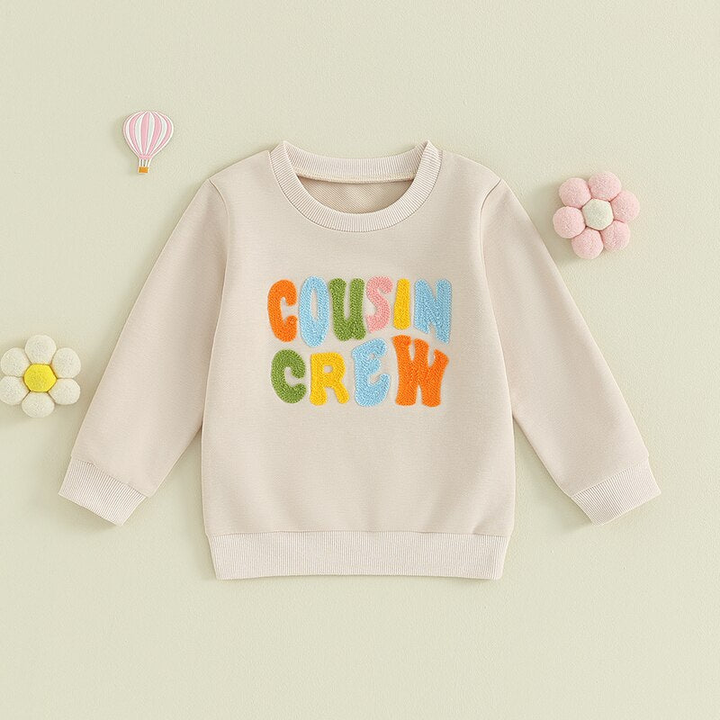 Cute fuzzy letter embroidery on a long sleeve toddler pullover, featuring round neck and cozy design for boys and girls by August + Willow.