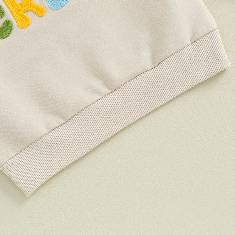Baby and toddler fuzzy letter embroidery crewneck pullover by August + Willow, featuring long sleeves and a cozy, loose fit.