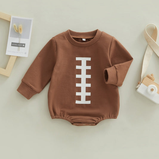 Baby boy girl jumpsuit by August + Willow featuring rugby football print, long sleeves, round neck, snap closure, bubble romper.