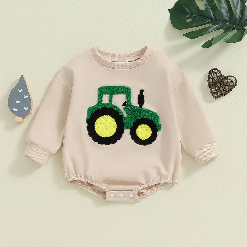 Baby girl and boy autumn romper by August + Willow, long sleeve crewneck with tractor embroidery, beige casual playsuit for infants.
