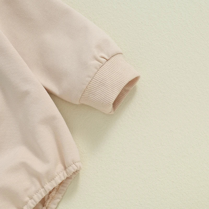 Baby girls and boys autumn romper by August + Willow, long sleeve crewneck with tractor embroidery, casual playsuit in beige.