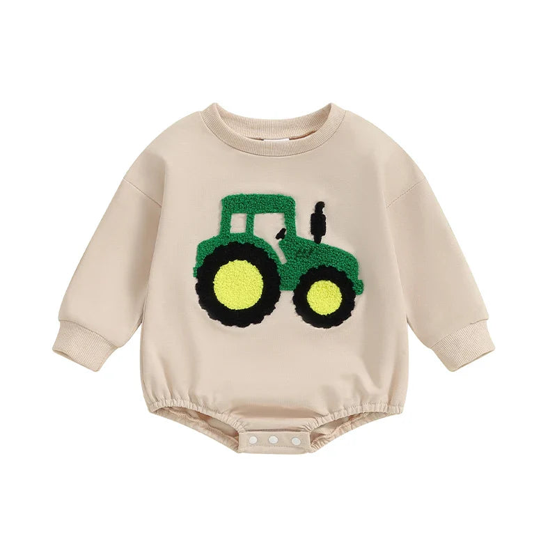 Baby girl and boy autumn romper by August + Willow, long sleeve crewneck playsuit with tractor embroidery, beige casual toddler outfit.