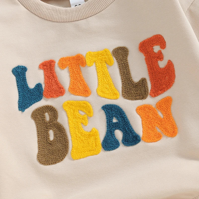 Baby girls and boys beige long sleeve bodysuit by August + Willow with letter embroidery, casual romper for infants 12-18 months.