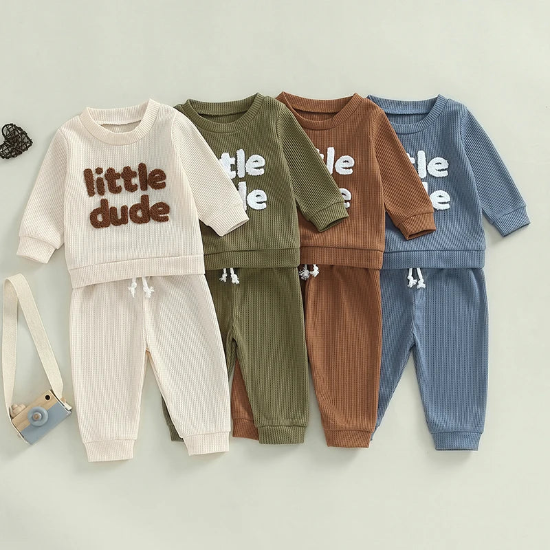 Baby toddler boys 2-piece waffle outfit by August + Willow with embroidered letter long-sleeve top and solid elastic waist pants.