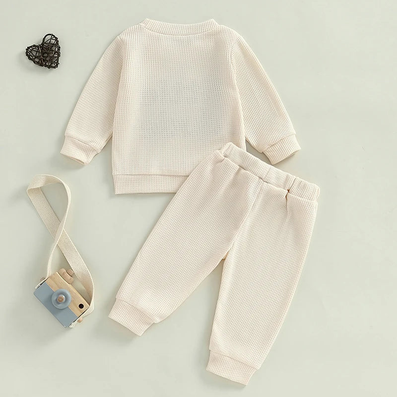 Baby toddler boys 2-piece waffle outfit by August + Willow with long sleeve letter embroidered top and elastic waist solid pants.