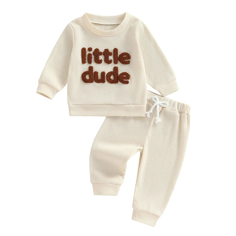 Baby boy outfit set with beige waffle long sleeve top and elastic waist solid pants, embroidered letter details, by August + Willow.