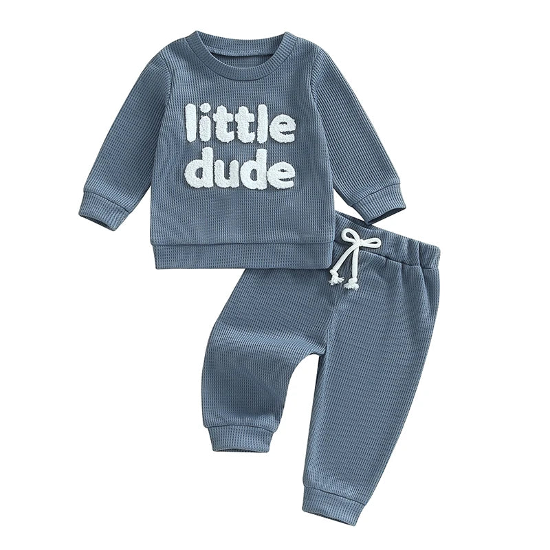 Baby toddler boys 2-piece waffle outfit with letter embroidery, long sleeve top, solid pants, elastic waist, in beige from August + Willow.