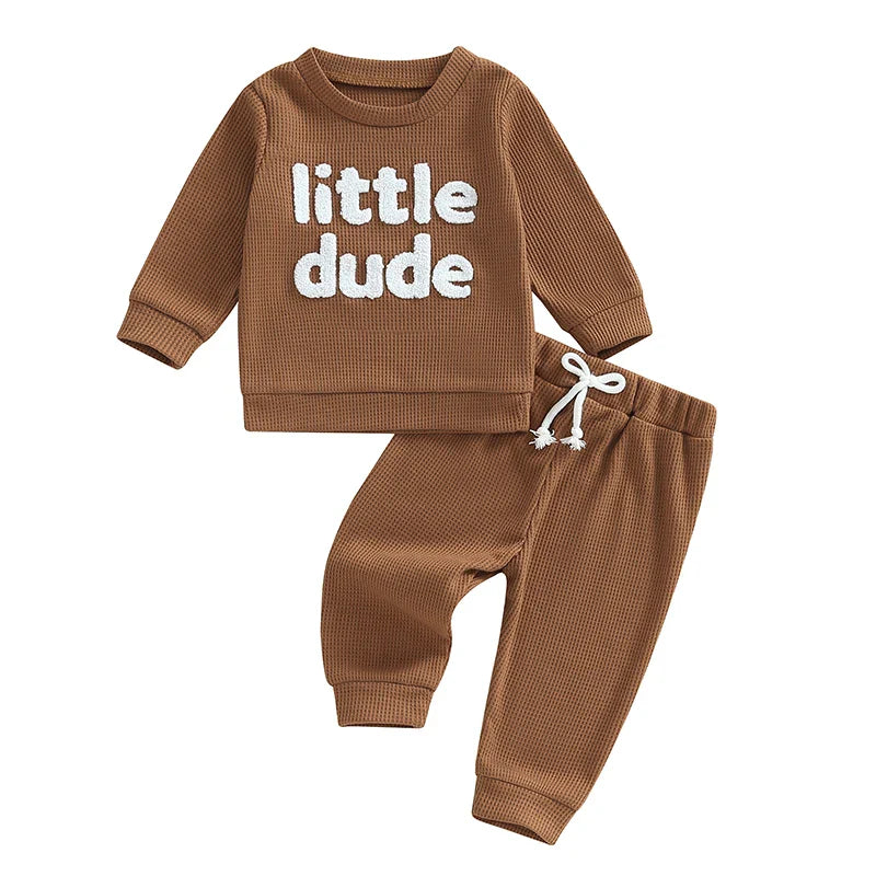 Baby toddler boys 2-piece waffle outfit with letter embroidery, long sleeve top, and elastic waist solid pants by August + Willow.