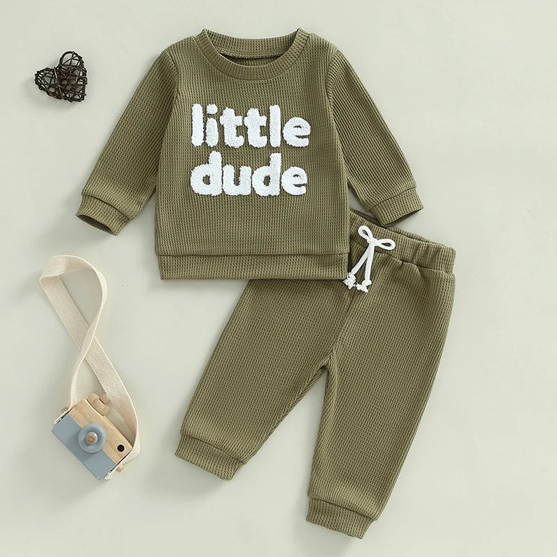 Baby toddler boys beige 2-piece waffle outfit with letter embroidery, long sleeve top and elastic waist solid pants by August + Willow.