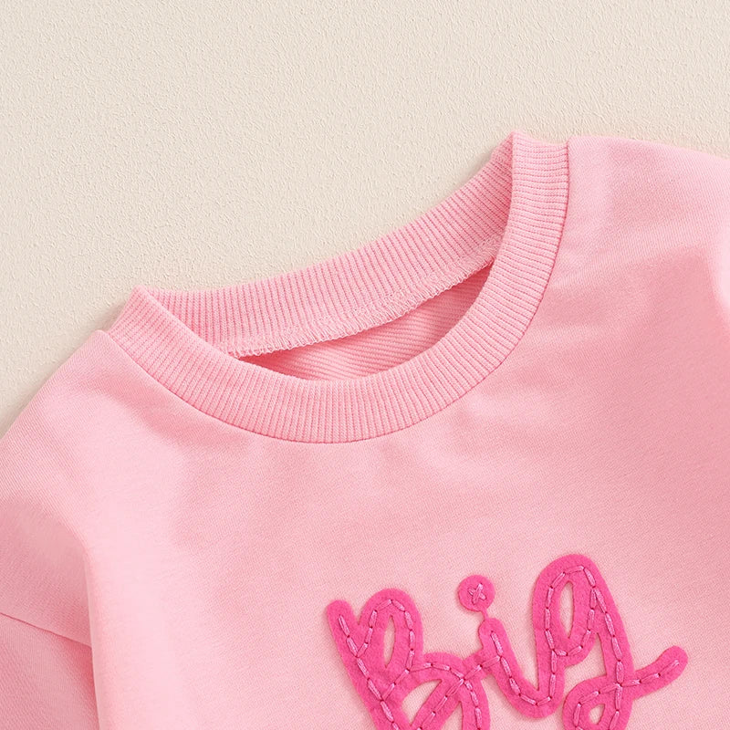 Toddler girls' beige long sleeve crewneck pullover top with letter embroidery from August + Willow, loose fit for baby and toddler outfits.