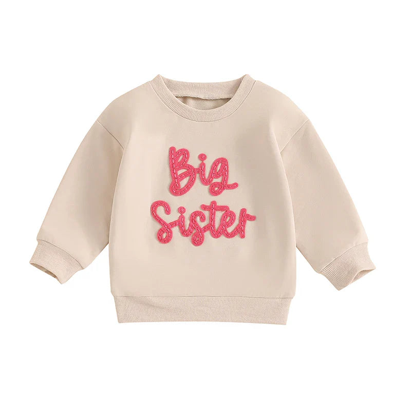 Beige toddler girls' long sleeve crewneck pullover top with letter embroidery, loose fit, by August + Willow, for baby and toddler outfits.