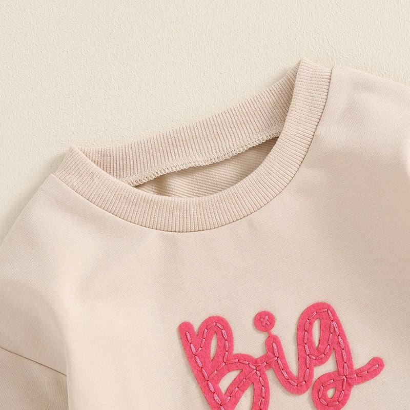 Toddler girls beige long sleeve crewneck pullover top with letter embroidery, loose fit, from August + Willow baby and toddler outfits.
