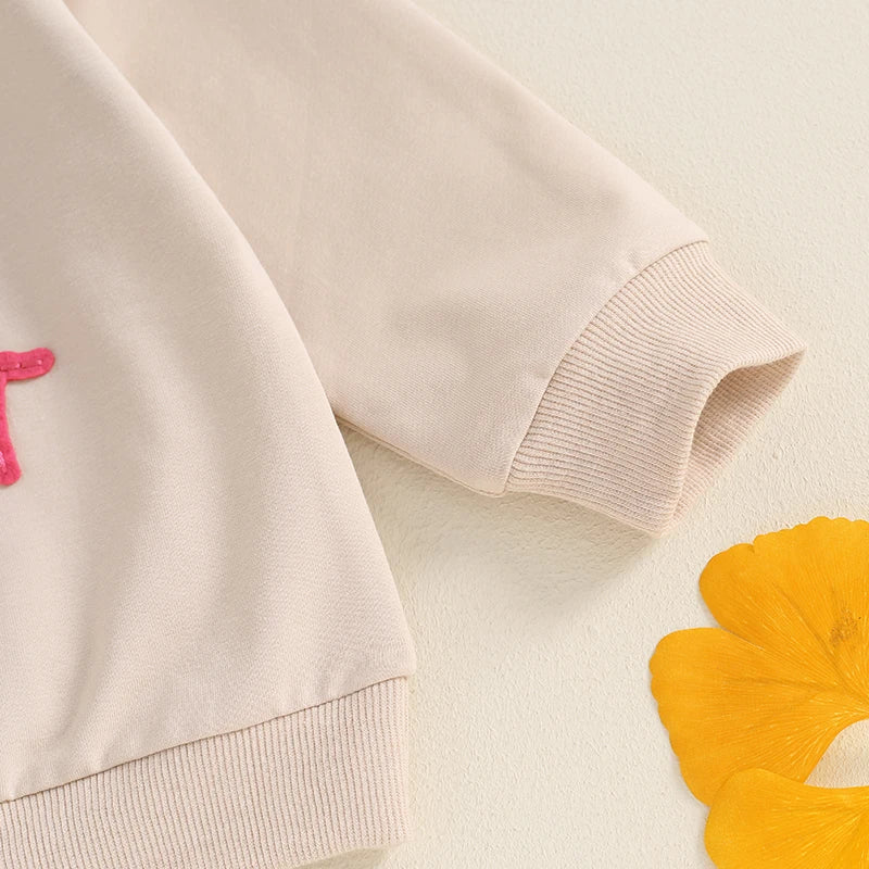 Toddler girls beige long sleeve crewneck pullover top with embroidered letter design, loose fit, from August + Willow.