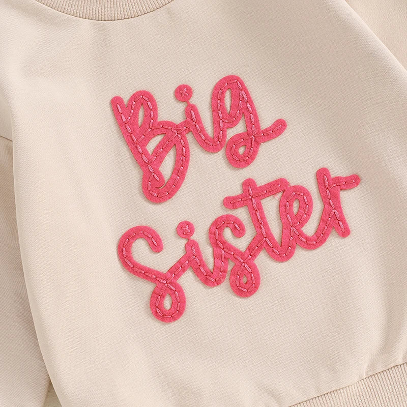 Toddler girls' beige long sleeve crewneck pullover from August + Willow with embroidered letter design, loose fit, suitable for 12-18 months.