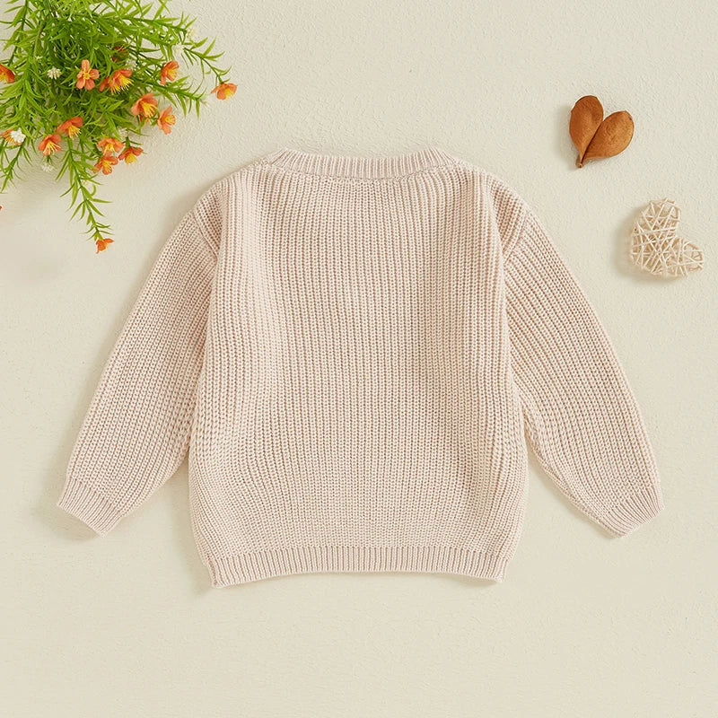 Baby girls' beige sweater from August + Willow with letter and flower embroidery, crew neck, long sleeves, perfect for fall and winter.