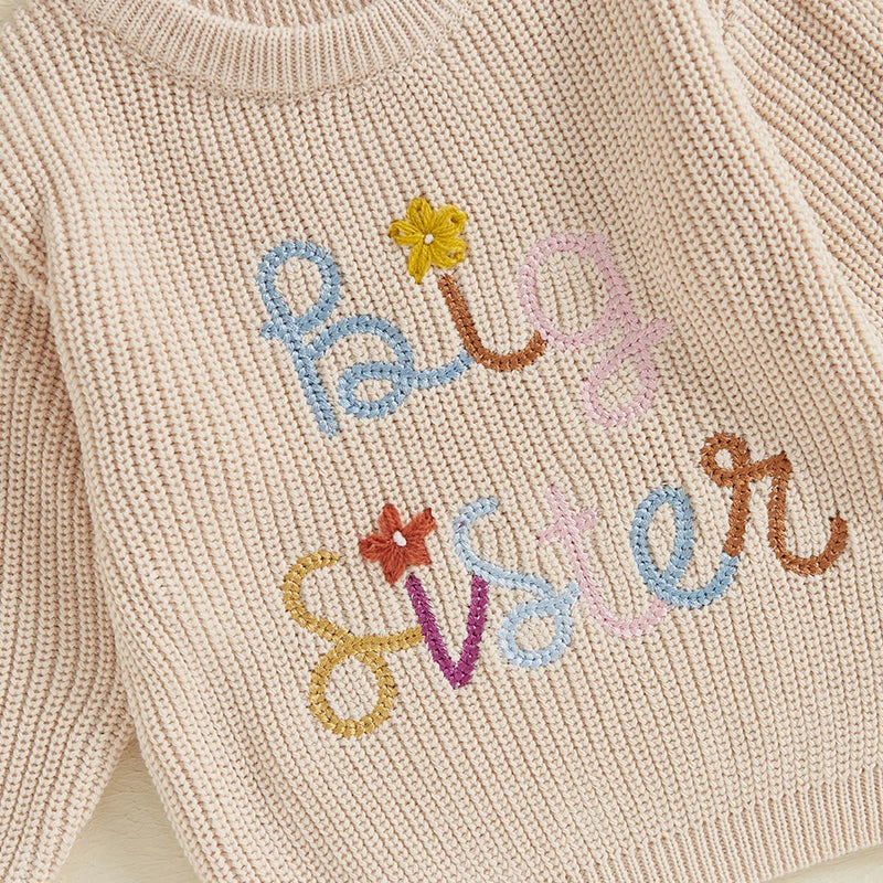 Baby girl fall winter sweater by August + Willow, beige crew neck pullover with letter and flower embroidery, long sleeves for toddlers.