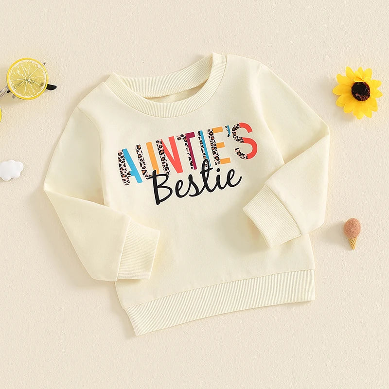 Baby girl toddler pullover top by August + Willow with casual letter print, crew neck, long sleeves, in beige for ages 6-12 months.