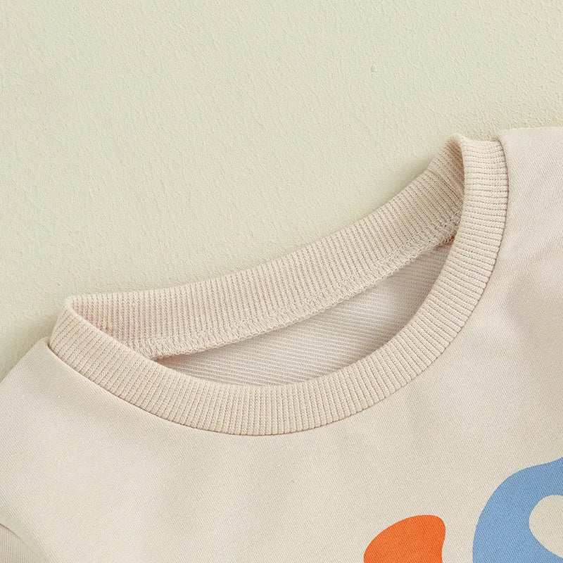 Baby and toddler boys and girls matching beige letter print crewneck tops from August + Willow, suitable for ages 12-18 months.
