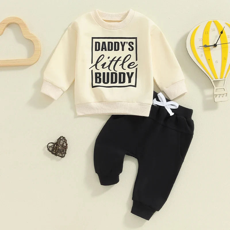 Baby toddler boys 2-piece fall outfit by August + Willow with letter print long sleeve top and solid pants, suitable for ages 0-6 months.