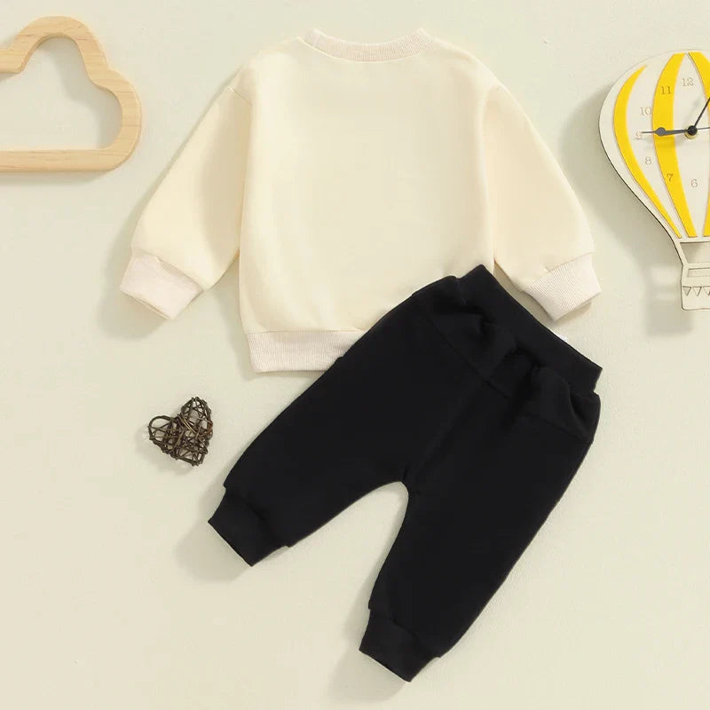 Baby toddler boys fall outfit by August + Willow featuring a letter print long sleeve top and solid color pants set.
