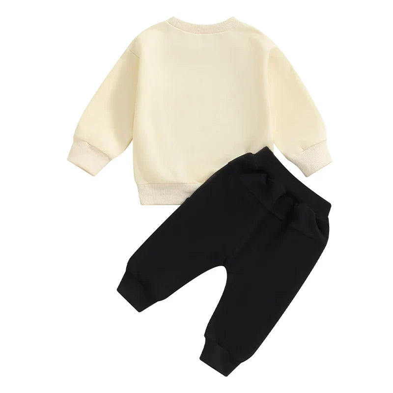 Baby toddler boys fall outfit set by August + Willow featuring a letter print long sleeve top and solid color pants for ages 0-6 months.