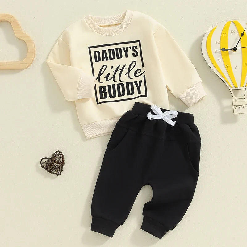Baby boy fall outfit set by August + Willow with letter print long sleeve top and solid color pants for ages 0-6 months.