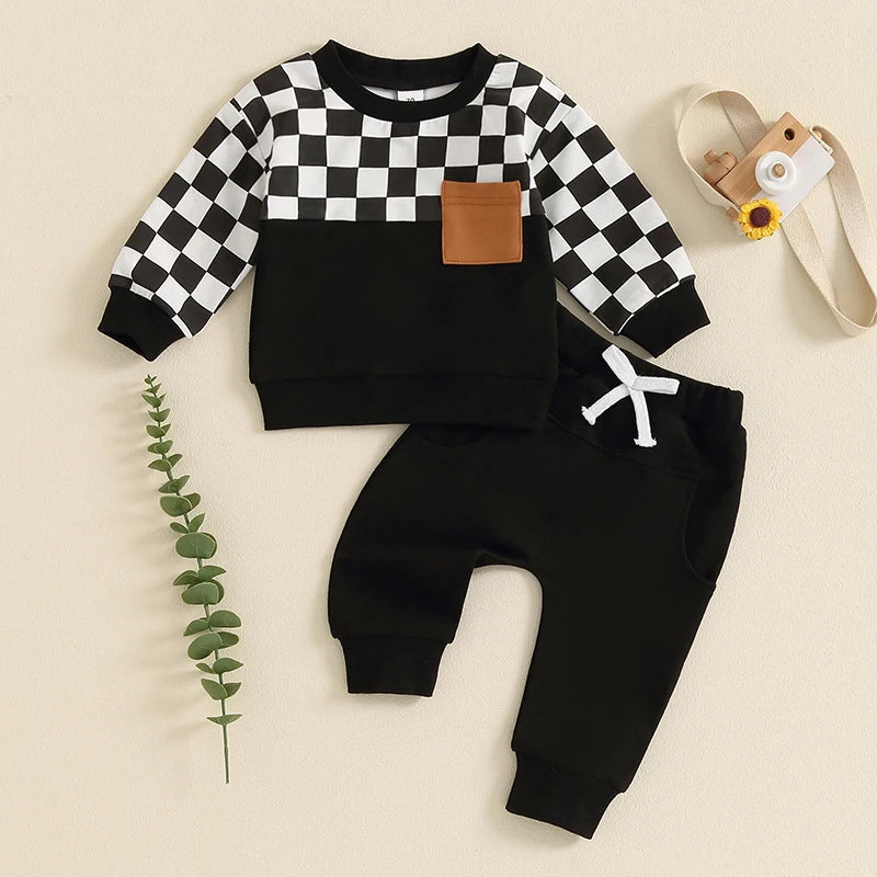Baby boy fall outfit set with black checkerboard long-sleeve top and solid long pants from August + Willow, 6-12 months.