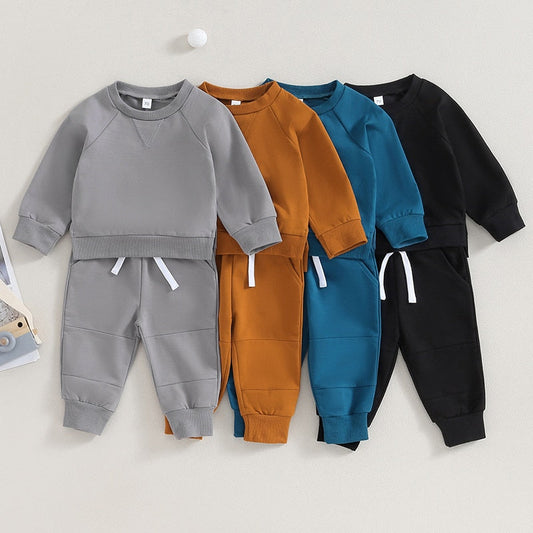 Baby toddler fall outfits set by August + Willow with long sleeve split hem tops and solid color pocket pants for boys and girls.