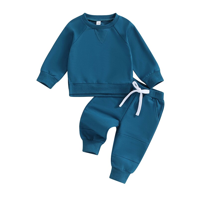 Toddler boy and girl fall outfits set with long sleeve split hem tops and solid color pants from August + Willow.