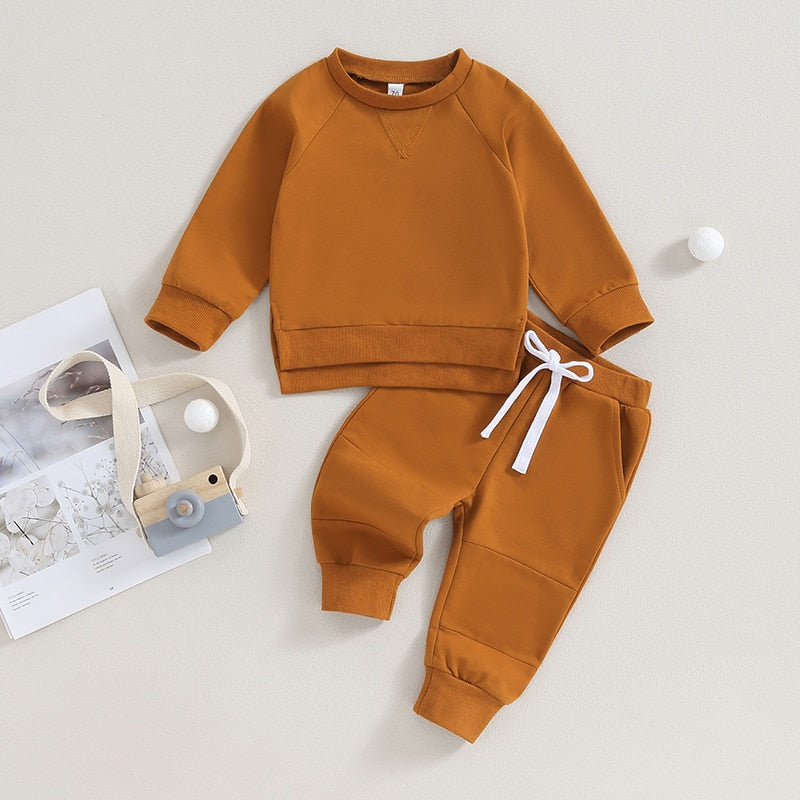 Black toddler baby outfit set with long sleeve split hem tops and pocket pants, by August + Willow, for boys and girls.