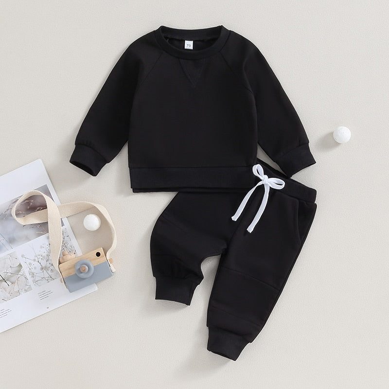 Toddler boys and girls fall outfit set with long sleeve split hem tops and pocket pants in solid black from August + Willow.