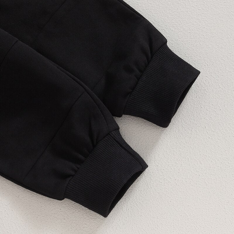 Toddler boys and girls fall outfit set with long sleeve split hem tops and pocket pants in solid black by August + Willow.