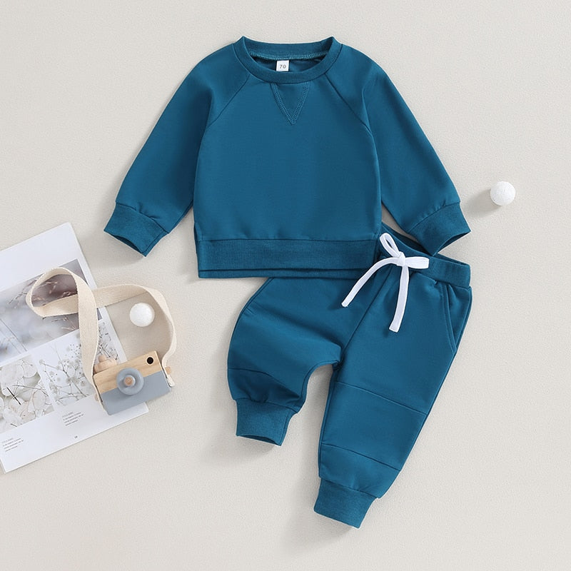 Black 2-piece toddler fall outfit with long sleeve split hem tops and pocket pants from August + Willow, suitable for boys and girls.