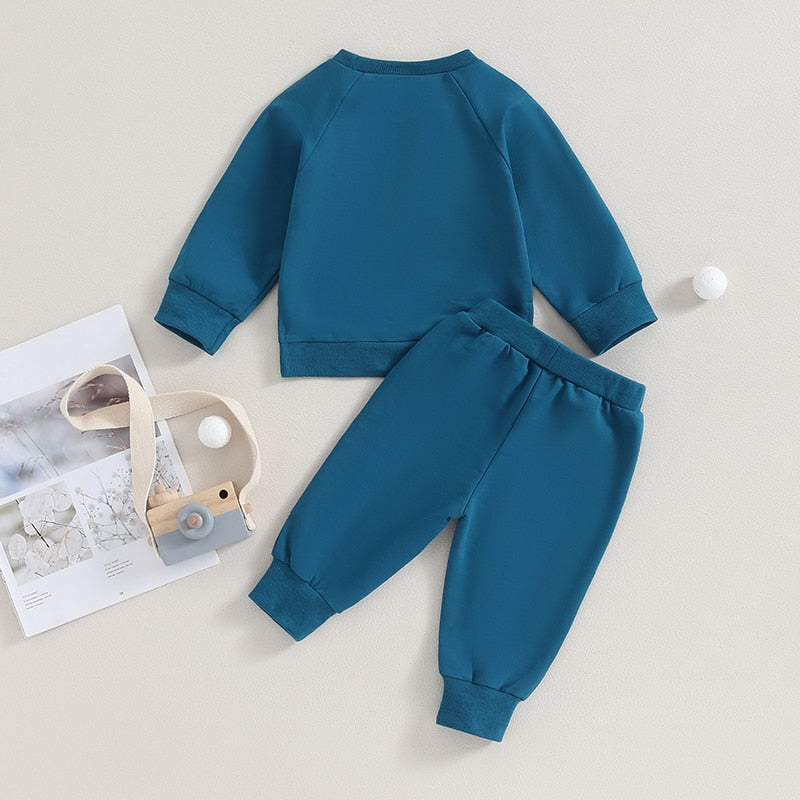 Black 2-piece fall toddler outfit set from August + Willow with long sleeve split hem tops and pocket pants for boys and girls.