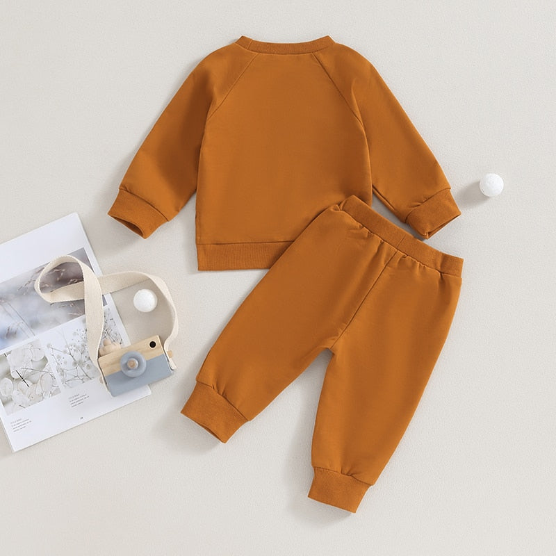 Baby toddler fall outfits by August + Willow with long sleeve split hem tops and solid color pants, suitable for boys and girls.