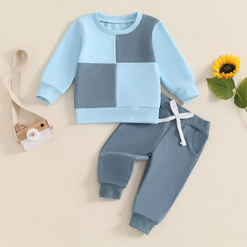 Baby boys' 2-piece fall outfit with long sleeve contrast color crewneck top and solid pants by August + Willow, for ages 6-12 months.