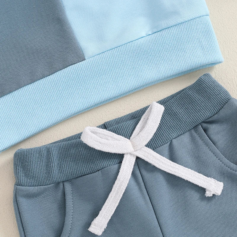 Baby boys fall outfit set with long sleeve contrast color crewneck top and solid pants from August + Willow, for ages 6-12 months.