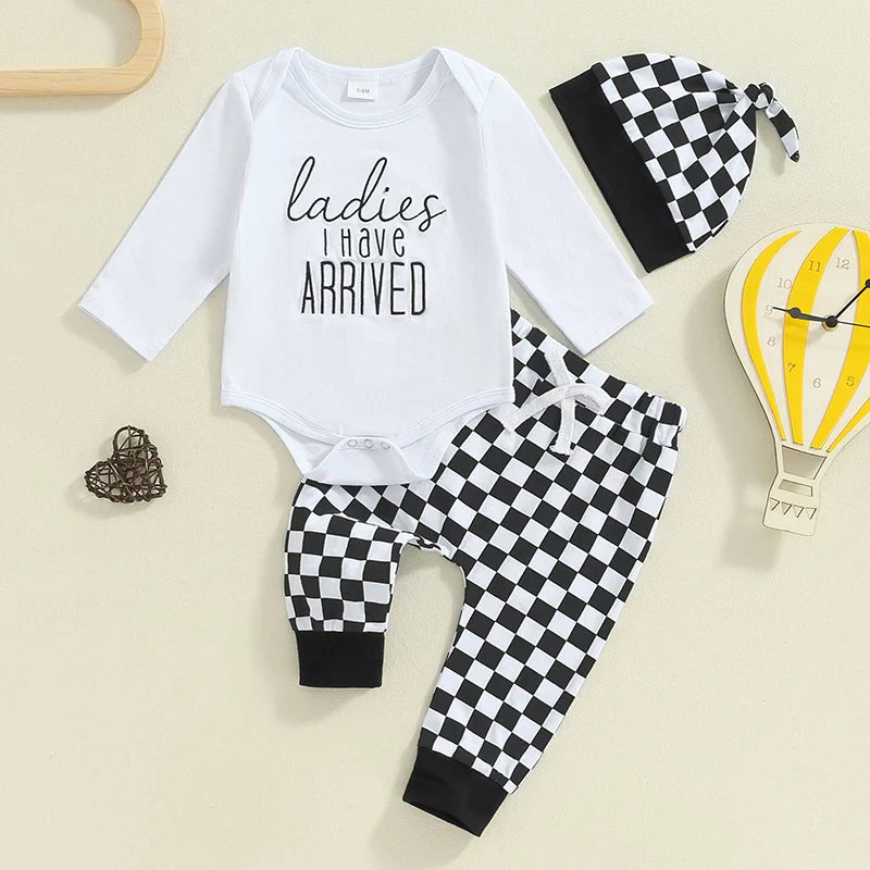 Baby boy fall outfit set from August + Willow featuring a letter print long sleeve romper, checker pants, and a matching beanie hat.
