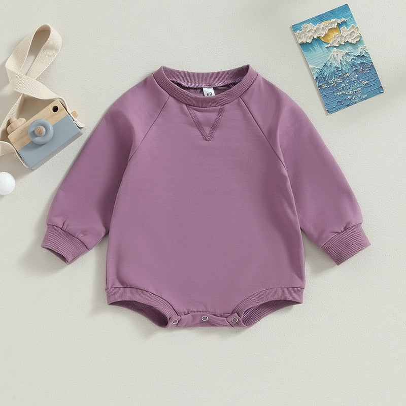 Baby toddler bodysuit in burgundy by August + Willow, solid long sleeve crew neck jumpsuit for fall, suitable for boys and girls.