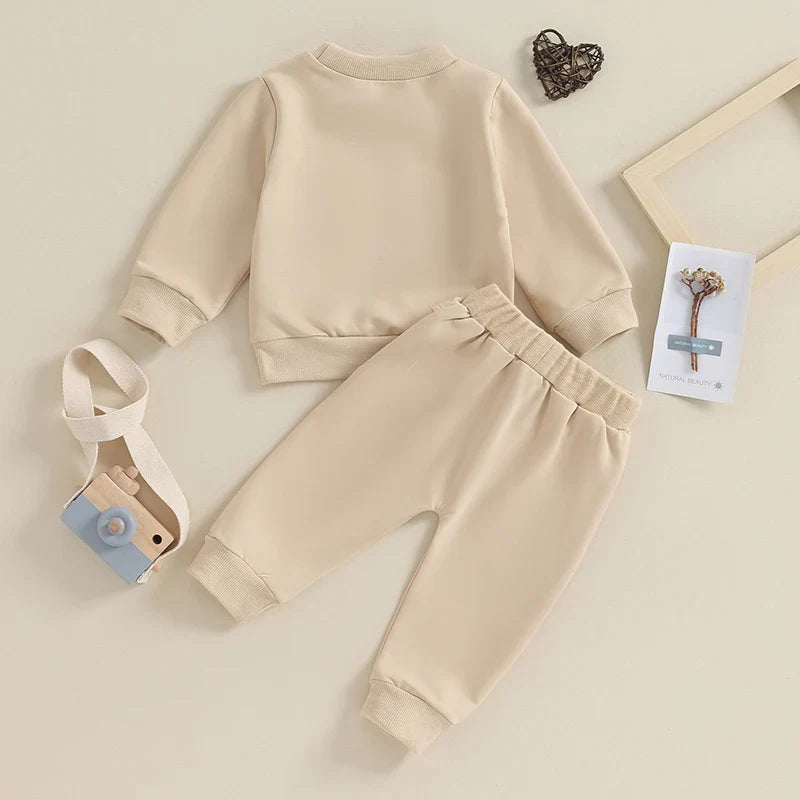 Gray toddler boy fall winter outfit set with long sleeve letter mama's boy crewneck top and jogger pants by August + Willow.