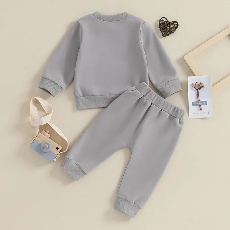 Gray toddler boys' fall winter outfit set from August + Willow with long sleeve letter Mamas Boy crewneck top and jogger pants.
